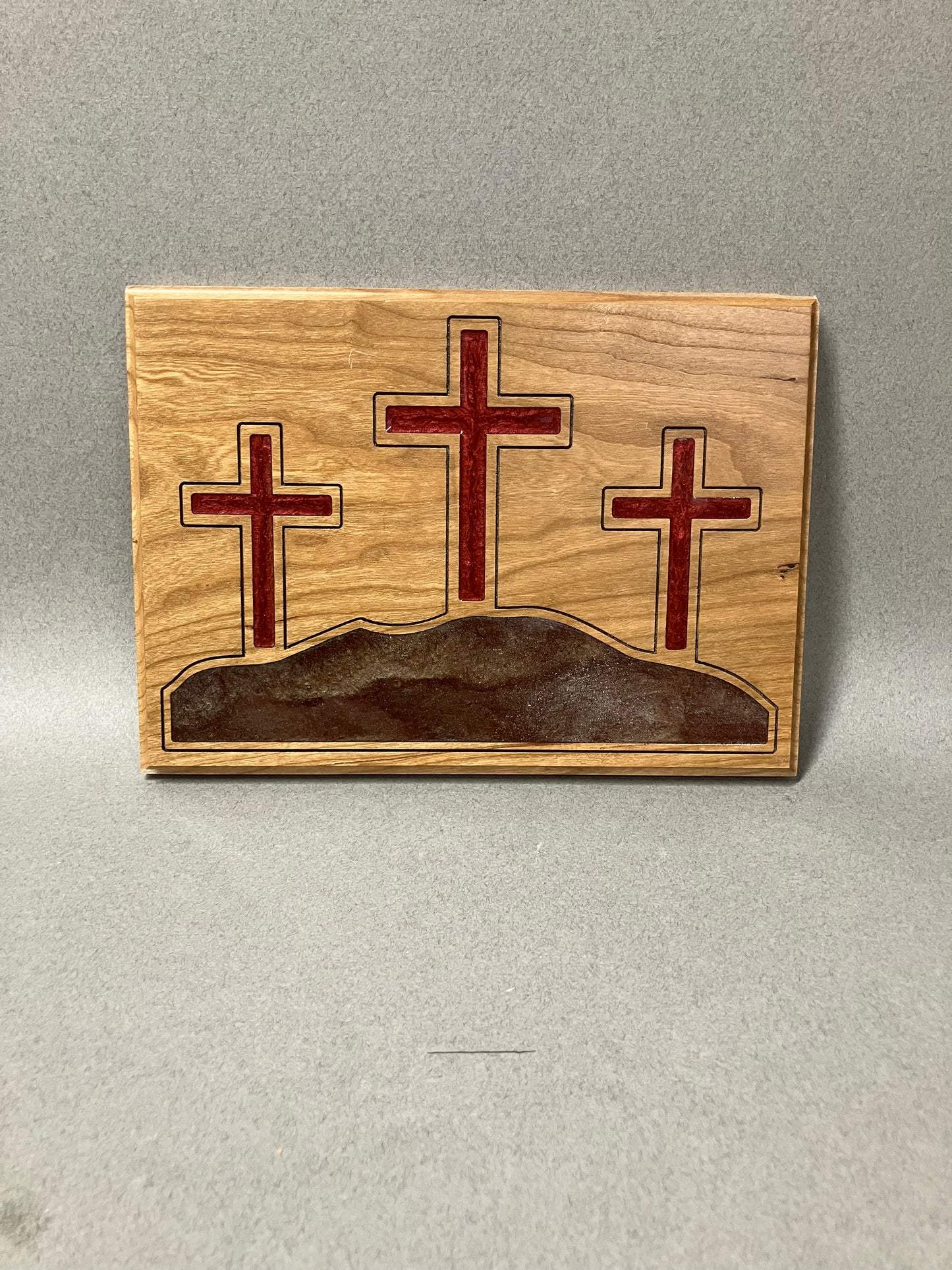 Three crosses on a hill and a red cross.