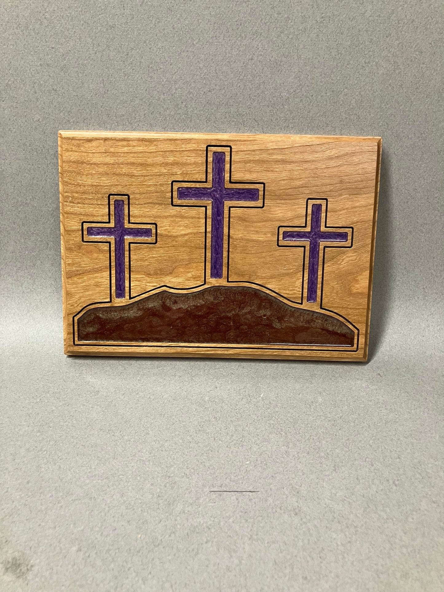 The three crosses on a hill in purple.