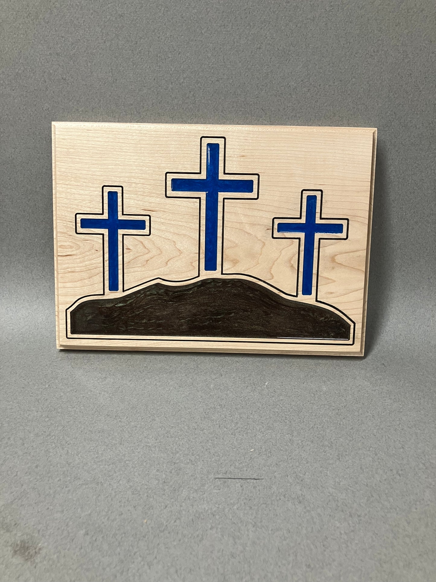Three crosses in Maple and blue.