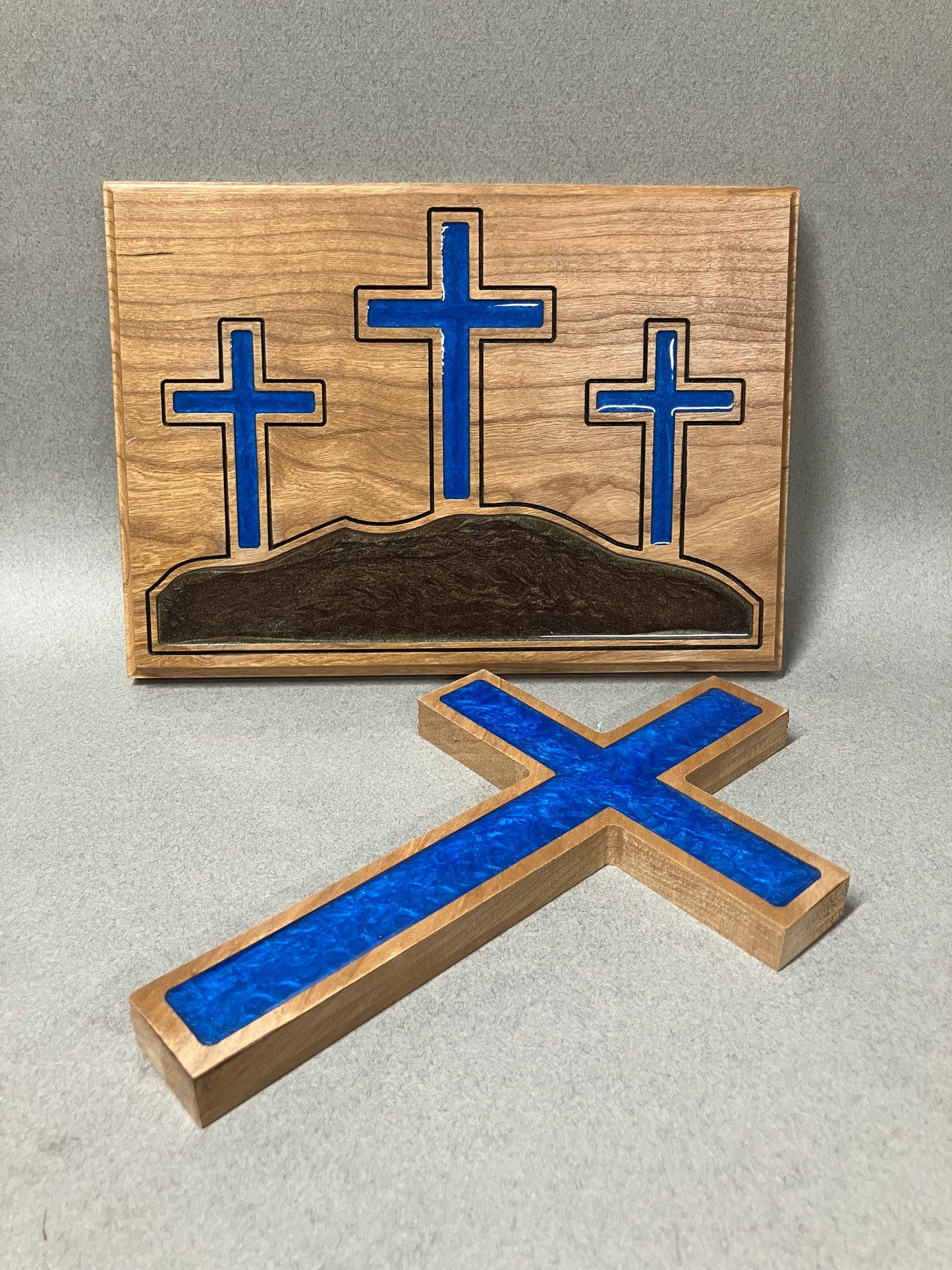 Three crosses on a hill and a blue cross.