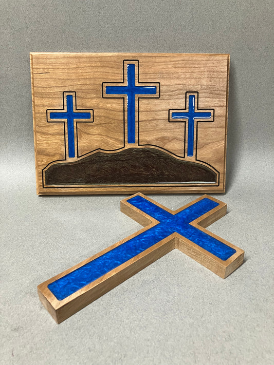Three crosses on a hill and a blue cross.