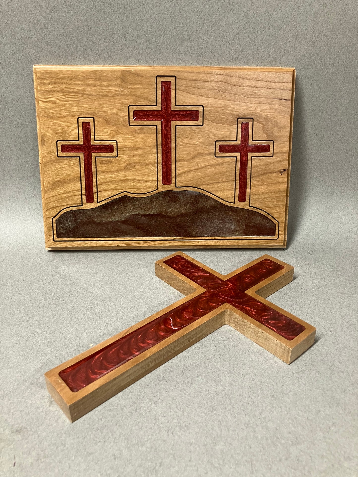 Three crosses on a hill and a red cross.