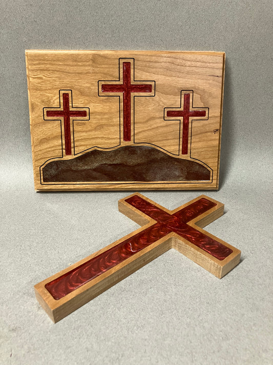 Three crosses on a hill and a red cross.